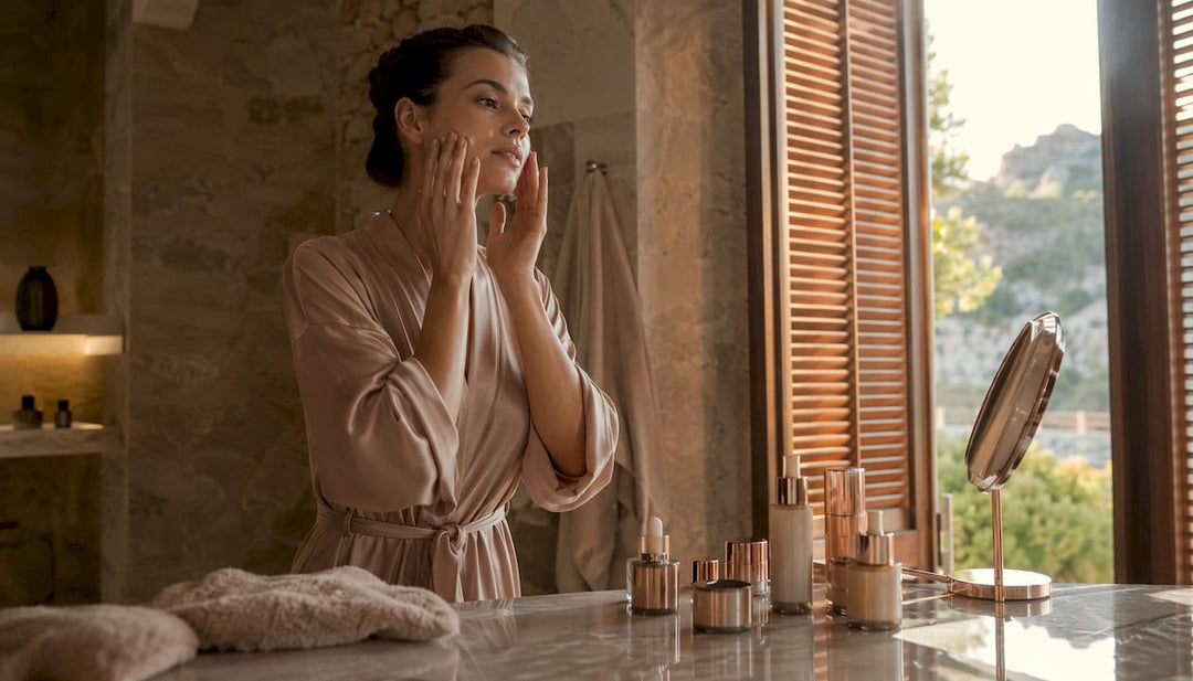 Woman applying serum in bathroom