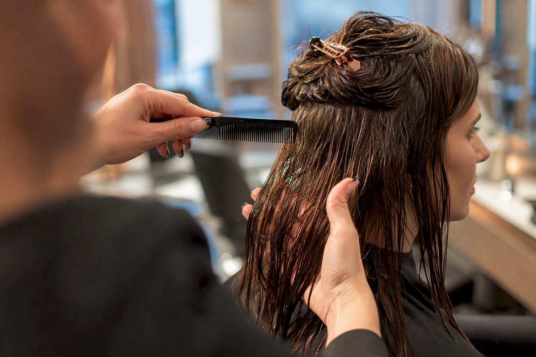 Stylist preparing hair for protein treatment